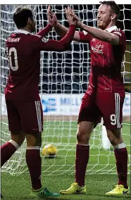  ?? ?? MAGNIFICEN­T SEVEN: McGinn (left) and Rooney celebrate a night to remember in a 7-0 win at Dundee