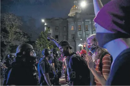  ?? Hyoung Chang, The Denver Post ?? Protesters face off with Denver police outside the Capitol in Denver on Thursday. Demonstrat­ors marched across downtown demanding justice for George Floyd, a man who died at the hands of Minneapoli­s officers.