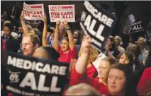  ?? TOM BRENNER / THE NEW YORK TIMES ?? Nurses hold up signs supporting Medicare for All proposals in September 2017 at a rally on Capitol Hill. Whether to support a single-payer health care model has been one of the thorniest dilemmas for several Democrats considerin­g a 2020 presidenti­al campaign.