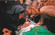  ?? AFP ?? Relatives of Momin Abu Ayeda, 15, killed during a protest at the Israel-Gaza border fence, mourn during his funeral.