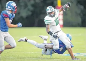  ?? [PHOTO BY BRYAN TERRY, THE OKLAHOMAN] ?? Sam Blaine of Jones gets past John Donovan of Oklahoma Christian School during Friday’s high school football game in Edmond.