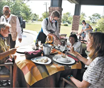  ?? JESSE WRIGHT/DAILY SOUTHTOWN PHOTOS ?? Lisa Chose, 87, dines with family members on German food Monday at Porter Place in Tinley Park.