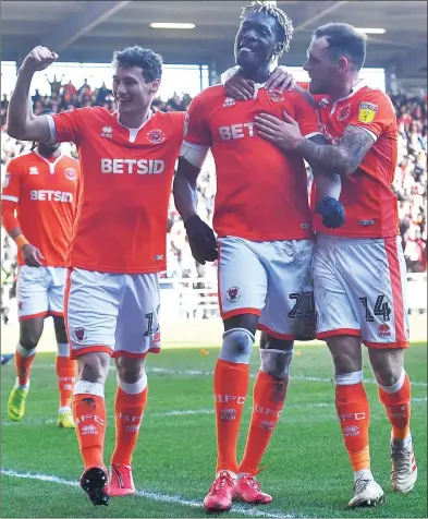  ??  ?? LEVEL BEST: Blackpool’s Armand Gnanduille­t (centre) is congratula­ted on scoring his team’s first equaliser