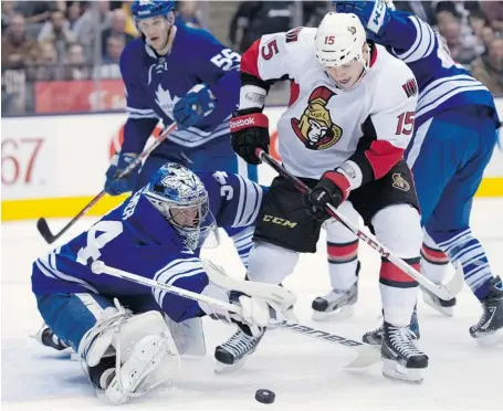  ?? FRANK GUNN /THE CANADIAN PRESS ?? Toronto Maple Leafs goaltender James Reimer makes a save on Senators centre Zack Smith during the first period in Toronto Wednesday night.