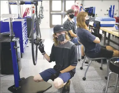  ?? (NWA Democrat-Gazette/Charlie Kaijo) ?? Cooper Heasley assembles a bike Thursday at Northwest Arkansas Community College in Bentonvill­e. The college’s Workforce and Economic Developmen­t Division held an open house Aug. 20 for its new Bicycle Technician Lab. In April, the college was awarded a $1,246,864 grant from the Walton Family Charitable Support Foundation. The money is being used for the phased rollout of the college’s bicycle assembly and repair technician program. Go to nwaonline.com/210913Dail­y/ for today’s photo gallery.