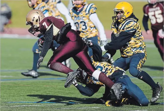  ?? RYAN PFEIFFER OSHAWA THIS WEEK ?? St. Peter’s Saints’ Jamie Hubble ran through Dwyer Saints’ Joseph Champagne during the LOSSA Metro Bowl football finals at the Oshawa Civic Field on Tuesday afternoon.