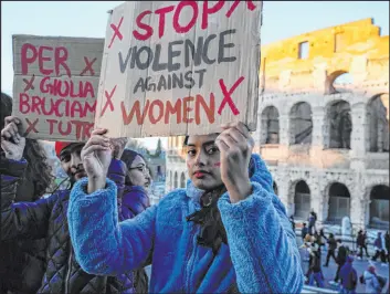  ?? Alessandra Tarantino The Associated Press ?? A woman holds a banner reading “Stop violence against women” during a protest on Internatio­nal Day for the Eliminatio­n of Violence against Women in Rome on Saturday.