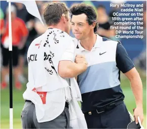  ??  ?? Rory McIlroy and caddie Niall OConnor on the 18th green after completing the first round of the DP World Tour Championsh­ip
