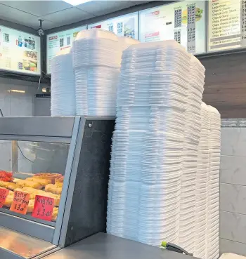  ?? ?? TALL ORDER: Takeaway containers piled high at Marco’s Fish Bar in Aberdeen.