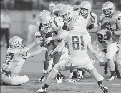  ?? Jill Knight/post-gazette ?? West Mifflin’s Jimmy Wheeler is tackled by the Belle Vernon defense in the first half Friday in Belle Vernon.