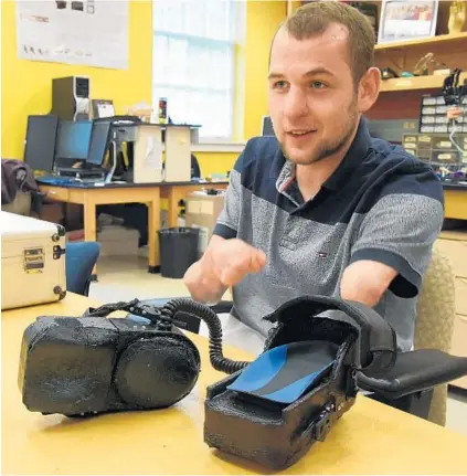  ?? AMY DAVIS/BALTIMORE SUN ?? Johns Hopkins biomedical engineerin­g student Gyorgy Levay created the GEAR device to help him control a computer with his feet after a meningitis infection cost him his hands. He hopes to sell the idea to an establishe­d company that can refine and market it.