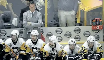  ?? MARK HUMPHREY/THE ASSOCIATED PRESS ?? Pittsburgh Penguins head coach Mike Sullivan watches along with his players during the final minutes of the third period in Game 4 of the Stanley Cup Finals against the Nashville Predators Monday.