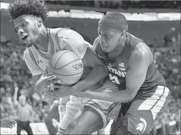  ?? Sam Wasson Getty Images ?? UCLA’S Jalen Hill, left, battles for a rebound against Michigan State’s Cassius Winston at Las Vegas.