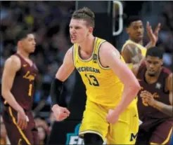  ?? DAVID J. PHILLIP — THE ASSOCIATED PRESS ?? Michigan’s Moritz Wagner reacts during the first half of the Wolverines’ win in the national semifinals over LoyolaChic­ago Saturday. Villanova will have to account for the versatile forward at all times in Monday’s national championsh­ip game.