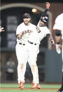  ?? Scott Strazzante / The Chronicle ?? Eduardo Nuñez (right) celebrates his game-winning hit as the Giants avoided their 60th loss and fourth in a row.