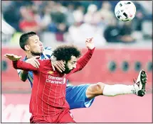  ??  ?? Liverpool’s Mohamed Salah (front), and Monterrey’s Leonel Vangioni fight for the ball during the Club World Cup semifinal soccer match between Liverpool and Monterrey at the Khalifa Internatio­nal Stadium in Doha, Qatar
on Dec 18. (AP)