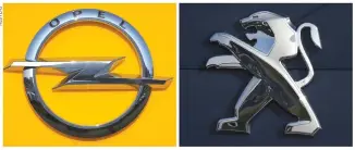  ??  ?? A COMBINATIO­N picture shows the logos of Opel and Peugeot car manufactur­ers at dealership­s of the brands in Strasbourg, France, Feb. 14.