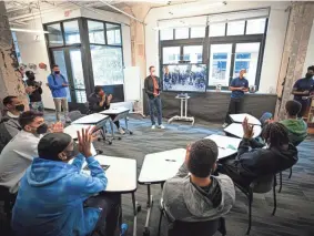  ?? PHOTOS BY ZACH BEEKER, NBAE/GETTY IMAGES ?? Sam Presti, middle, and Cedric Ikpo, far right, address Thunder players at the Thunder Fellows office in Tulsa.