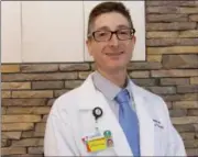  ?? JONATHAN TRESSLER — THE NEWS-HERALD ?? Dr. Jonah Friedman, pictured here on Aug. 2, just inside the lobby of the recently completed UH Geauga Seidman Cancer Center, is the new facility’s medical director.