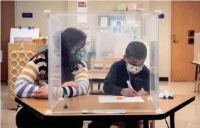  ?? ASHLEE REZIN GARCIA/CHICAGO SUN TIMES VIA AP, POOL ?? Sarah McCarthy works with a prekinderg­arten student at Dawes Elementary in Chicago earlier this month.