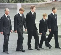  ??  ?? The Duke of Edinburgh, Prince William, Earl Althorp, Prince Harry and Prince Charles walk behind Diana, the Princess of Wales’ funeral cortege.