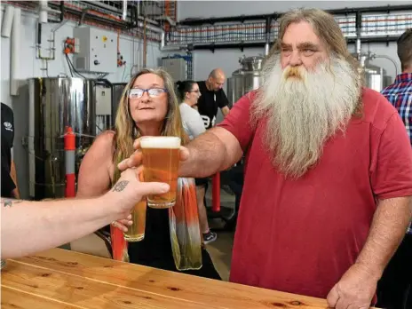 ?? Photos: Kevin Farmer ?? BEARDS AND BREWS: Megan and Garry Hadlow sample the beers on Volcanic Brewery’s opening day at the weekend.