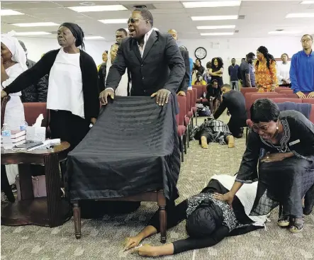  ?? LARRY WONG ?? Congregati­on members are overcome with grief at a church service at Solid Rock Church Internatio­nal on Sept. 24, 2017. Three women from the church died after a stolen truck crashed into their minivan. The image has earned Larry Wong a nomination in the...