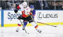  ??  ?? Mikael Backlund and the Calgary Flames couldn’t shake Mika Zibanejad and the New York Rangers Friday night, as the home side scored a 4-3 win.