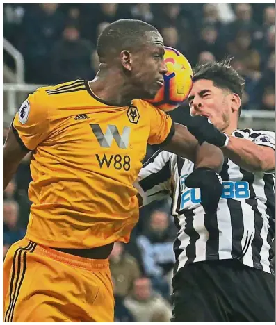  ??  ?? Arguable: Wolverhamp­ton Wanderers’ Willy Boly (left) appears to make contact with Newcastle’s Ayoze Perez in a challenge for the ball during the Premier League match on Sunday.