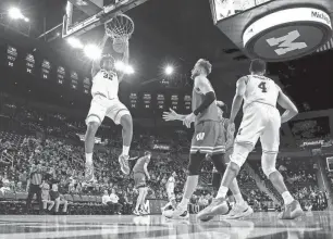  ?? RICK OSENTOSKI/USA TODAY SPORTS ?? Michigan’s Tarris Reed Jr. helped spark a 19-6 run in Wednesday night’s victory against Wisconsin at Crisler Center.