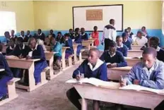  ?? Rex features ?? Take note Pupils in Tanzania. A new policy being introduced by the government aims to free families from any fees and contributi­ons for 11 years of schooling.