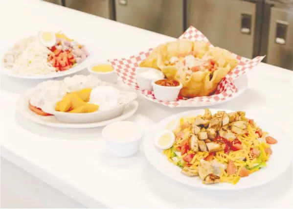  ?? PHOTO BY CHLOE GOODMAN ?? Salad choices at Track’s End range from hearty to light lunches. Clockwise from top are a chef’s salad, taco salad in fried tortilla shell, grilled chicken salad and homemade chicken salad plate.