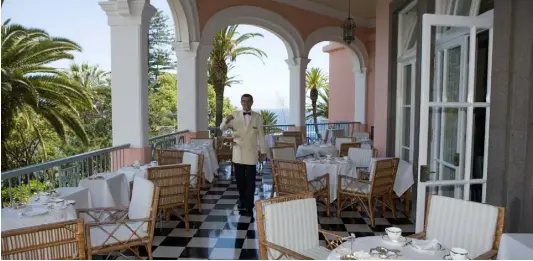  ??  ?? A waiter serves afternoon tea on the terrace at Reid’s Palace Hotel, Funchal. Churchill and George Bernard Show were both guests here