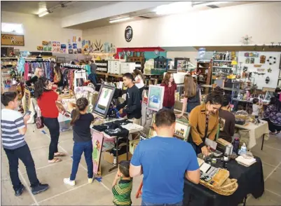  ??  ?? A number of art and apparel vendors set up shop inside of the store Odds and Ends in El Centro during the Downtown Dollars event on Saturday afternoon in El Centro. VINCENT