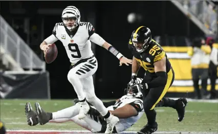  ?? Associated Press ?? Bengals quarterbac­k Joe Burrow eludes Steelers defensive tackle Chris Wormley during the second half Sunday at Acrisure Stadium.