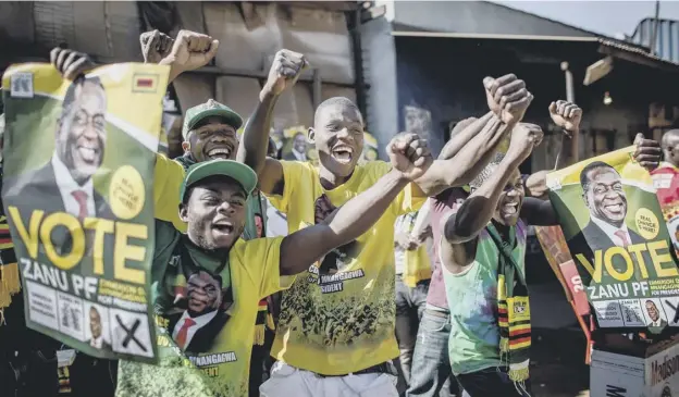  ?? PICTURE: AFP/GETTY ?? Jubilant Zanu PF supporters celebrate the victory of Emmerson Mnangagwa in the presidenti­al election, but the country remains divided