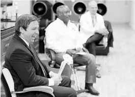 ?? JOHN RAOUX/AP ?? Gov. Ron DeSantis, left, laughs during a discussion with salon owners in Orange County about opening businesses such as barber shops and nail and hair salons.