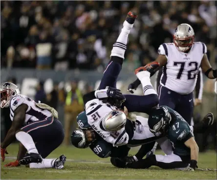  ?? MATT ROURKE - THE ASSOCIATED PRESS ?? New England Patriots’ Tom Brady (12) is tackled by Philadelph­ia Eagles’ Derek Barnett (96) and Nate Gerry (47) during the first half of an NFL football game, Sunday, Nov. 17, 2019, in Philadelph­ia.