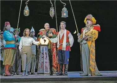  ?? PHOTOS BY KEN HOWARD/COURTESY SANTA FE OPERA ?? RIGHT: Daniela Mack as Isabella, Scott Conner as Mustafa, Jack Swanson as Lindoro and Patrick Carfizzi as Taddeo in Santa Fe Opera’s production of L’italiana in Algeri.