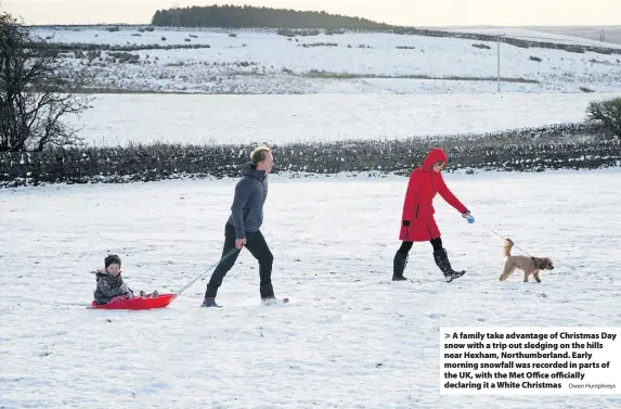  ?? Owen Humphreys ?? A family take advantage of Christmas Day snow with a trip out sledging on the hills near Hexham, Northumber­land. Early morning snowfall was recorded in parts of the UK, with the Met Office officially declaring it a White Christmas