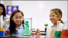  ?? PROVIDED BY DMNS ?? Girls undertake a chemistry experiment as part of the Girls & Science event at Denver Museum of Nature & Science in 2022. The event returns March 3, kicking off a month of virtual programmin­g.