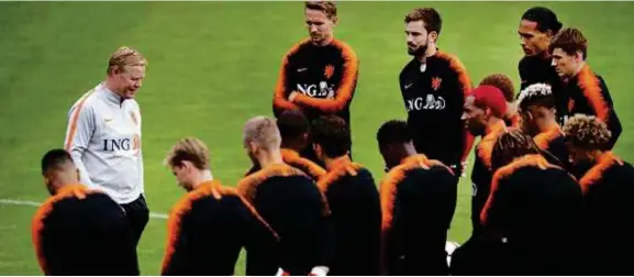  ??  ?? Koeman (kiri) memperkata­kan sesuatu kepada skuad Belanda pada sesi latihan di Rotterdam sebelum bertemu Ireland Utara awal pagi Jumaat ini.