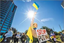  ?? Francine Orr Los Angeles Times ?? MEMBERS OF the Ukrainian community in Los Angeles protest Russia’s invasion of Ukraine at the federal building in Westwood on Thursday.