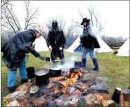  ?? Staff photograph by Flip Putthoff ?? Civil War re-enactors including Daniel Bugner (left) dish up a lunch of stew Saturday during living history programs at Pea Ridge National Military Park. The Battle of Pea Ridge was fought March 6-8, 1862.