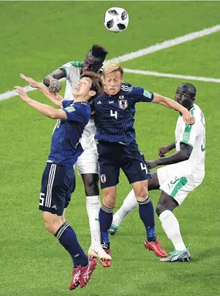  ?? PHOTO: GETTY IMAGES ?? Crunch . . . Salif Sane, of Senegal, wins a header over Keisuke Honda and Yuya Osako, of Japan, during their group H match at Ekaterinbu­rg Arena yesterday.