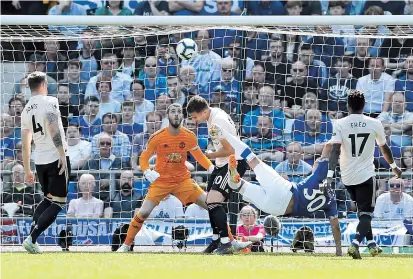  ??  ?? Striker Richarliso­n (in blue) scores Everton’s first goal against Manchester United during their English Premier League match at Goodison Park, Liverpool, yesterday. Everton won 4-0. — Reuters