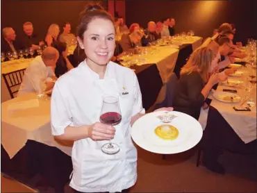  ?? STEVE MacNAULL/The Okanagan Weekend ?? Sous chef Heather Brumwell led the first half of the recent Traditiona­l Italian Culinary Class at Mission Hill Family Estate in West Kelowna, which included the giant ravioli cacio e pepe she’s holding that was paired with Mission Hill’s 2016 Reserve Pinot Noir.