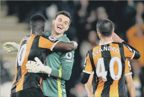  ?? PICTURE: RICHARD SELLERS/PA WIRE ?? EXULTANT: Hull City’s Alfred N’Diaye hugs goalkeeper Eldin Jakupovic as they celebrate last night’s 4-2 Premier League home victory over Middlesbro­ugh.