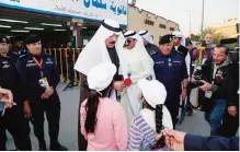  ??  ?? Children greet Deputy Prime Minister and Interior Minister Sheikh Mohammad Al-Khaled Al-Hamad Al-Sabah as he arrives at a polling station yesterday.