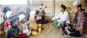  ??  ?? BATANG HARI, Indonesia: This photo taken on May 19, 2017 shows children from the “Orang Rimba” tribe, who have converted to Islam and given up their nomadic ways, wearing Islamic skullcaps and hijabs as they gather to recite the Holy Quran in Jambi...